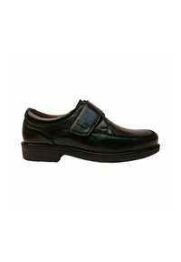 Zapato de cuero negro con un acabado suave, correa de velcro, punta redondeada y suela de goma resistente, diseñado para la comodidad y facilidad de uso.