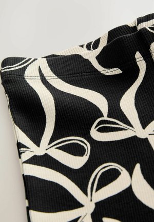 Black fabric with a ribbed texture featuring a white ribbon pattern. The design includes varied ribbon shapes and outlines, with visible stitching.