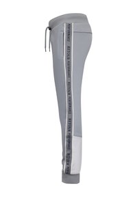 Grijze sportbroek met een taps toelopend ontwerp, voorzien van een contrasterende verticale logo-streep, een elastische tailleband en een zachte stof.