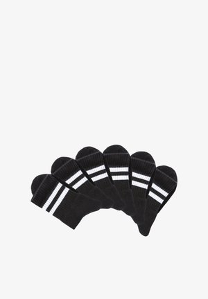 Six pairs of black crew socks with two white horizontal stripes near the top, arranged in a fan shape on a white background.