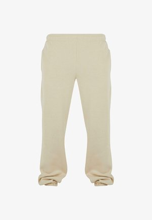Pantaloni della tuta beige realizzati in morbido cotone misto, con vita e polsini elasticizzati, vestibilità rilassata e texture liscia.