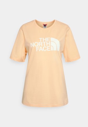 Meruňkově zbarvené bavlněné tričko s krátkým rukávem, na přední straně s bílým logem "THE NORTH FACE".