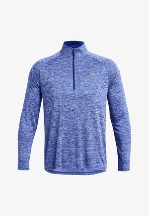 Camisa de hombre de manga larga con cremallera en una tela azul jaspeada. Presenta un cuello alto y un pequeño logo en el pecho. Textura suave en toda la prenda.