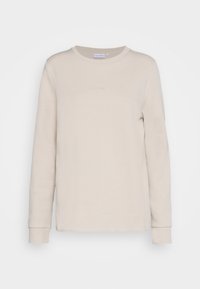 Felpa beige a maniche lunghe con colletto rotondo, con il logo Calvin Klein discreto centrato sul petto, polsini e orlo a coste.