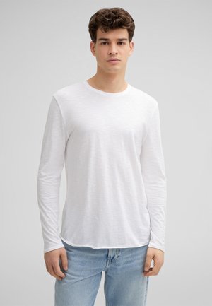 White long-sleeve shirt with a crew neckline, made of lightweight fabric, features a subtle textured pattern and a relaxed fit.
