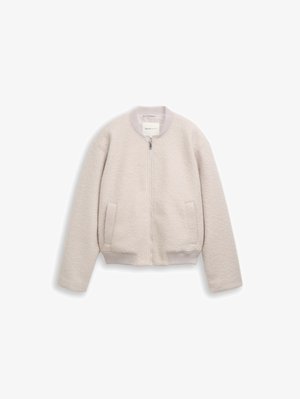 Φωτεινό μπεζ μπουφάν με φερμουάρ, με ριμπ γιακά, μανσέτες και σιρίτι, διαθέτει δύο μπροστινές τσέπες και μαλακό υφή υφάσματος.