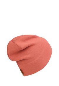Coral beanie made of soft fabric with a loose fit, rounded top, and subtle stitch detailing. Features a small leather accent on the side.