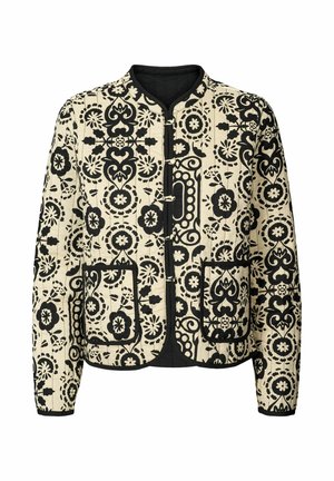 Quilted jacket in cream with bold black floral pattern, featuring a round neckline, front closure, and two large pockets.