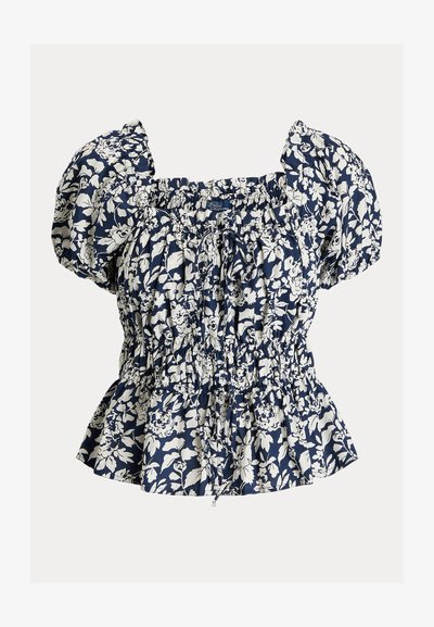 Jūras zila blūze ar baltu ziedu rakstu, pūkainām piedurknēm, smocētu jostu un regulējamu auklu. Kokvilnas sajaukums, teksturēts audums, pepluma siluets.