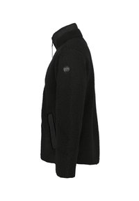 Musta fleece-takki, jossa on korkea kaulus, vetoketjukiinnitys, teksturoitu kangas, kaksi sivutaskua ja pyöreä logoaksentti vasemmassa hihassa.