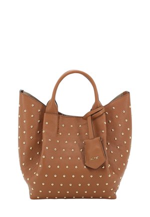 Brown leather tote bag with gold studs, rounded shape, dual handles, and a small detachable tag featuring the brand name.