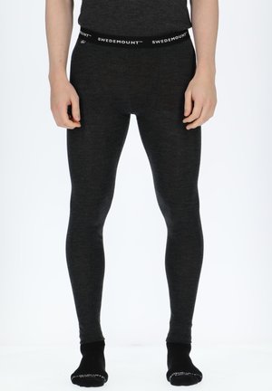 Schwarze thermische Leggings aus einem weichen, strukturierten Stoff, mit einem markierten Bund und einem schmalen Design, das sich den Beinen anpasst.