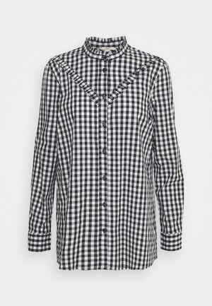 Zwart-wit geruit gingham overhemd met lange mouwen, opstaande kraag, knopen aan de voorkant en ruches langs het schouderstuk. Gemaakt van lichtgewicht stof.