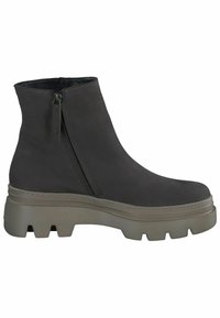 Bottine noire à cheville avec fermeture éclair latérale et semelle épaisse beige à crampons, dessus lisse et bout arrondi, vue de côté extérieur.