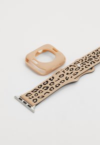 Silicone smartwatch strap in beige with black leopard pattern; includes a square protective case in matching color. Silver hardware accents.
