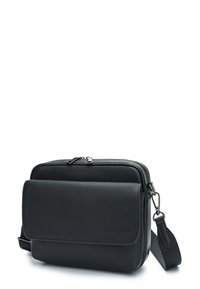 Black leather crossbody bag with textured surface, two zippered compartments, and adjustable strap. Front features a magnetic flap closure.