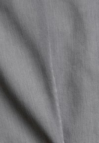 Gray fabric with a smooth texture, featuring a subtle diagonal weave pattern. The material appears sturdy and is folded to show depth.