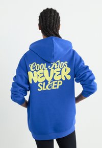 Blue hoodie featuring a large yellow text design on the back that reads "COOL KIDS NEVER SLEEP." Made of soft fabric with a relaxed fit.