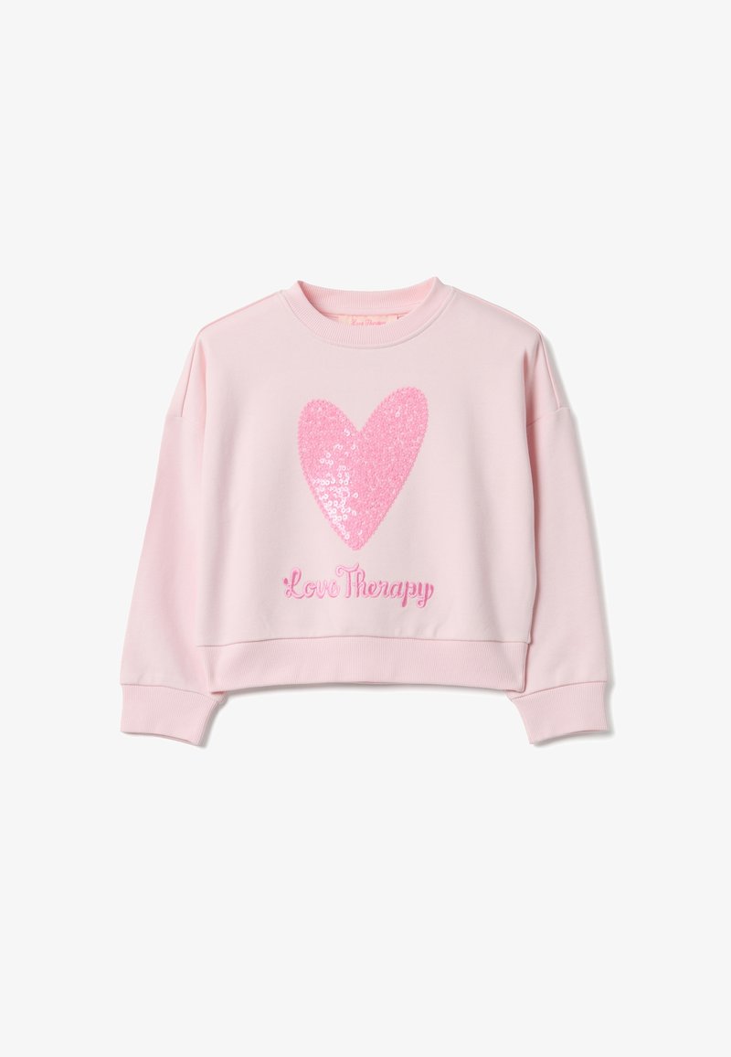 Pink cropped sweatshirt featuring a large sequined heart design and "Love Therapy" embroidered in pink at the bottom. Textured fabric, relaxed fit.