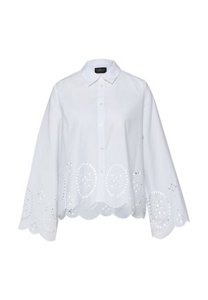 Chemise blanche boutonnée avec ourlet festonné et manches arborant des motifs floraux ajourés circulaires.
