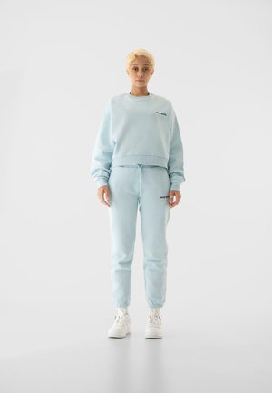 ESSENTIAL  - Tracksuit bottoms - babyblue