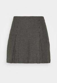 Jupe mini à carreaux noir et blanc avec une coupe droite, présentant des coutures avant et une texture subtile. Aucun fermoir ni poche visibles.