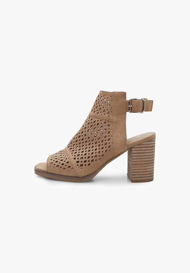 Atvērtu pirkstu augstpapēžu sandales gaiši brūnā zamšā. Iezīmēta ar perforētu dizainu, potītes siksniņu ar sprādzi un saliktu koka papēdi.