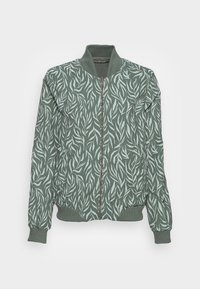 Zielona bombka z wzorem liści w jaśniejszym odcieniu, z zapięciem na zamek i ściągaczami przy mankietach oraz u dołu.