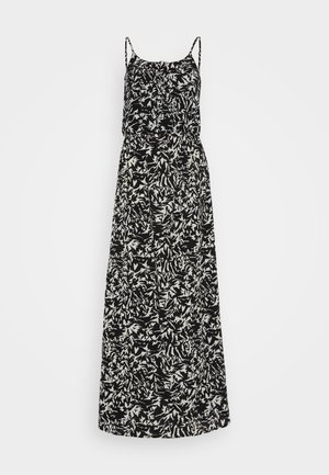 Robe maxi avec des motifs de feuilles abstraites noir et blanc, des bretelles spaghetti, un corsage ajusté et une jupe fluide. Fabriquée en tissu léger.