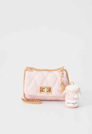 Pink quilted handbag with gold chain strap and clasp. Includes a detachable charm resembling a jar with a lid and decorative accents.