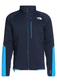 Marinblå isolerad jacka med hög krage, kontrasterande ljusblå accenter på ärmarna och strukturerat tyg. Har en framdragkedja.