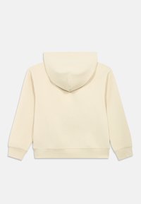 Krémová mikina s kapucí, měkké textury, dlouhými rukávy, žebrovanými manžetami a rovného střihu. Bez viditelných log nebo vzorů.