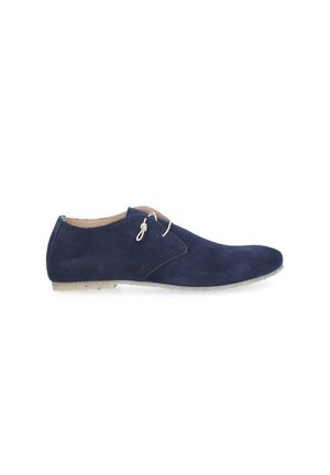 Navy blue suede men's derby shoe with beige laces and light beige sole shown in side view on white background.