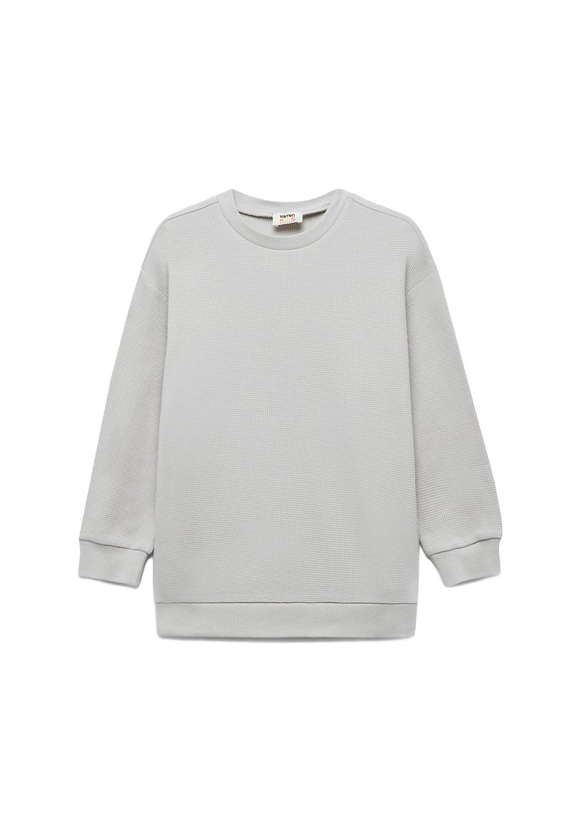 Jasnoszara bawełniana bluza z fakturowanej tkaniny, okrągłym dekoltem i długimi rękawami. Posiada ściągacze przy mankietach i u dołu dla dodatkowego wykończenia.