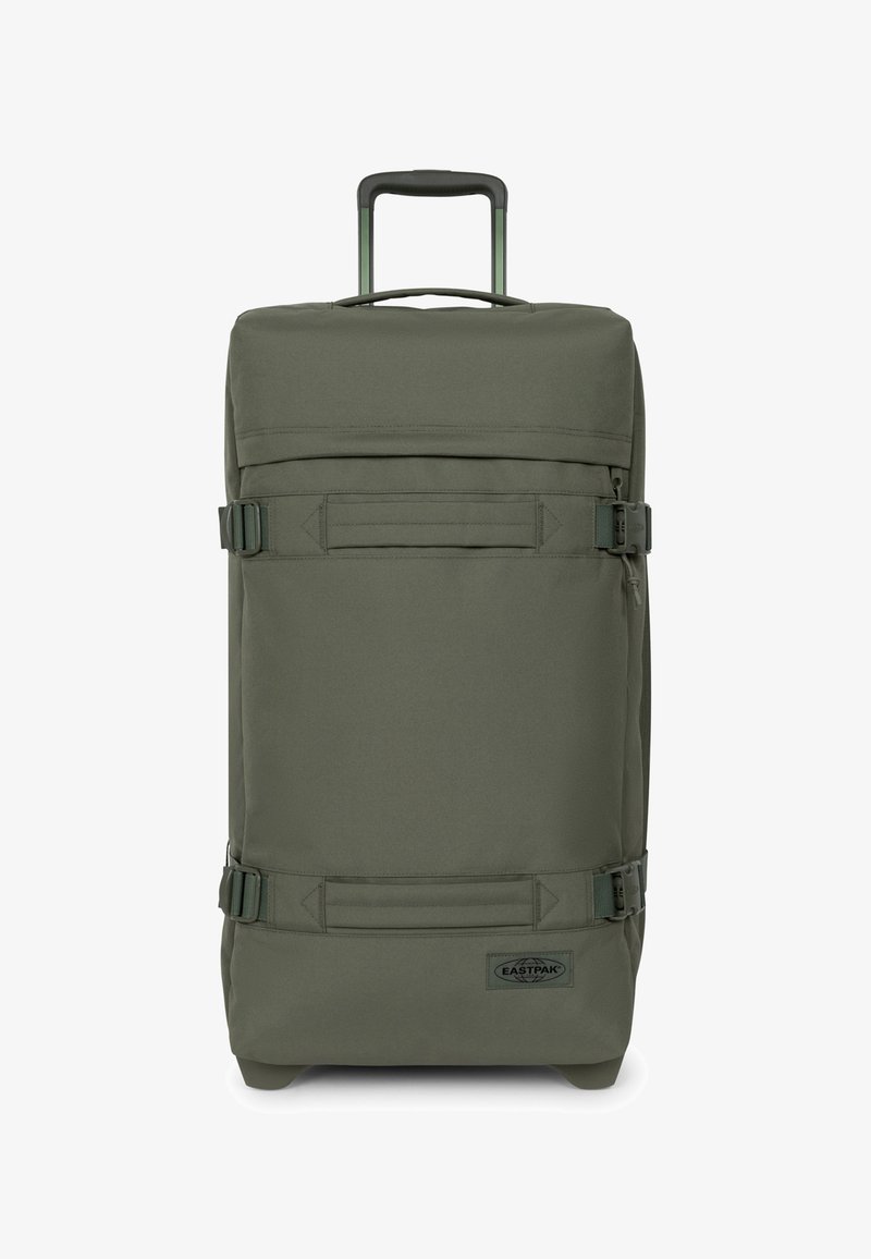 Valise de voyage kaki avec une poignée rétractable, deux sangles latérales, une forme rectangulaire et une texture en tissu. Présente un logo sur le devant.