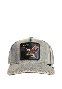 Denim cap in light blue with a black patch featuring an embroidered eagle, "SAVAGE" text above, and a structured, curved brim.