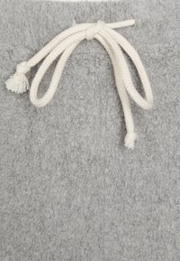 Soft gray fleece fabric with a tied off-white braided drawstring looped through a sewn hem.