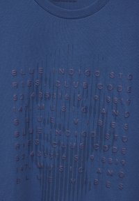 Modré tričko s kulatým výstřihem a texturovaným potiskem v tmavě modré barvě, zobrazující fráze, čísla a vzory po celé látce.