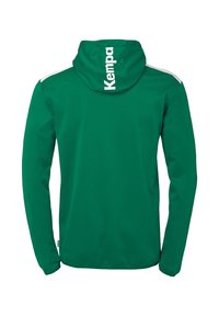 Groene hoodie met lange mouwen van gladde stof, met witte accenten op de schouders en een wit "Kempa" logo op de capuchon.
