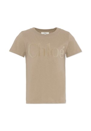 T-shirt en coton beige avec un logo "Chloé" ton sur ton en relief sur le devant, col rond classique et manches courtes. Texture douce, coupe standard.
