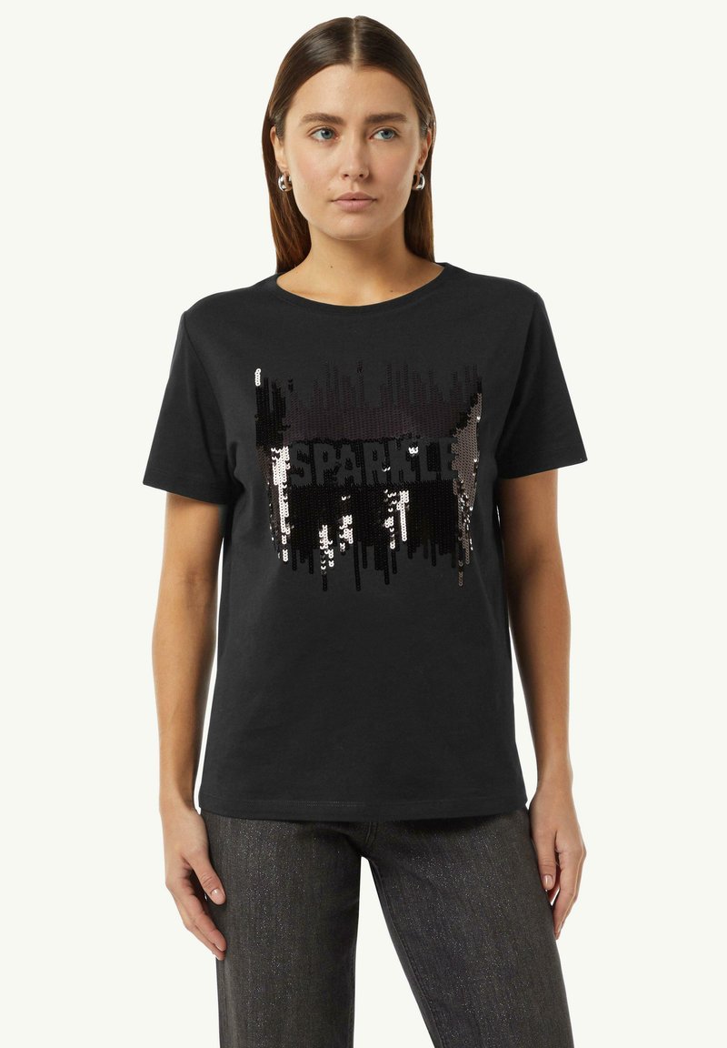 Black cotton T-shirt featuring a sequin design with the word "SPARKLE" in bold letters. Fitted shape with short sleeves, rounded neckline.