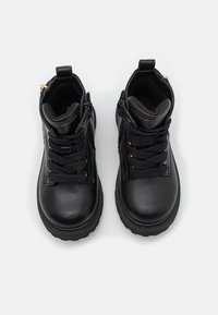 Černé kožené kotníkové boty s hladkým povrchem, kulatou špičkou, gumovou podrážkou a zlatými kovovými prvky. Mají šněrování a boční zip.