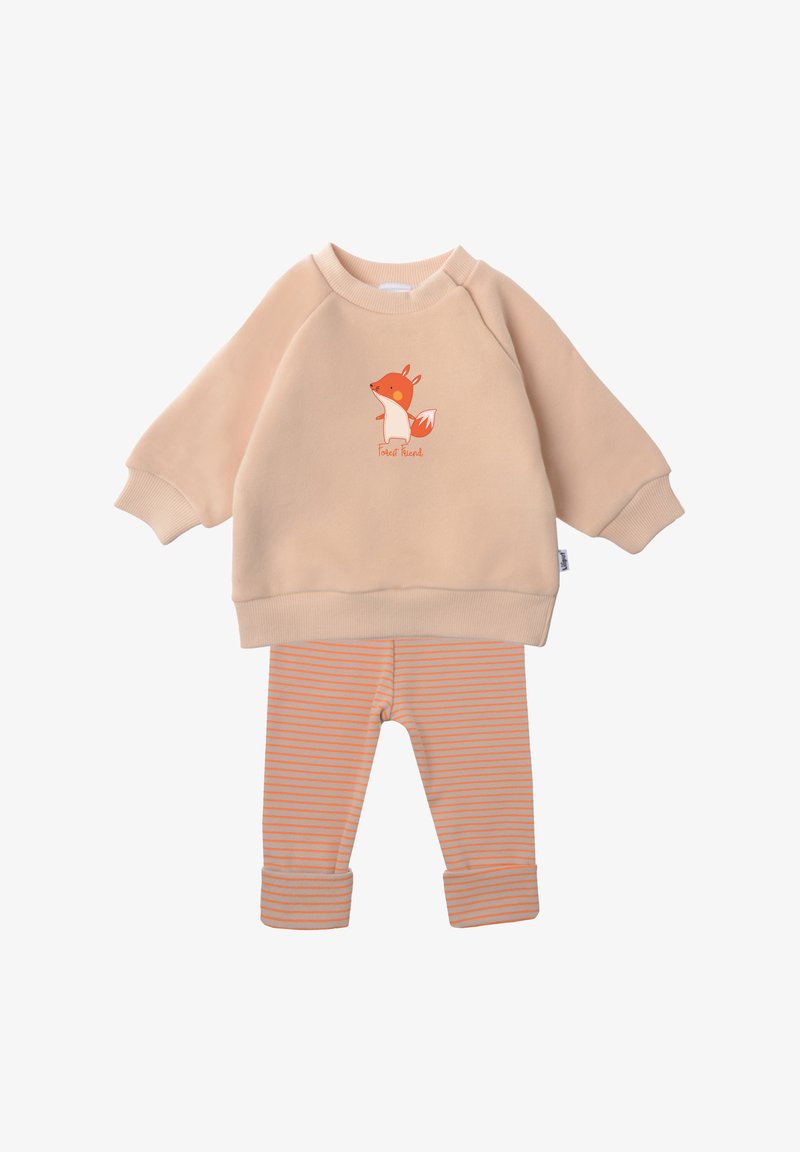 Beige sweatshirt with fox graphic and "Forest Friend" text, paired with orange and gray striped leggings, cuffed at the ankles. Soft material.