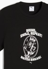 Black cotton t-shirt featuring a white cartoon graphic of a water bottle with arms and legs, alongside the text: "Drink, Smile, Repeat! Water Break!"