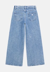 Wide-leg light blue denim jeans with a high waist, featuring two back pockets and subtle stitching details.
