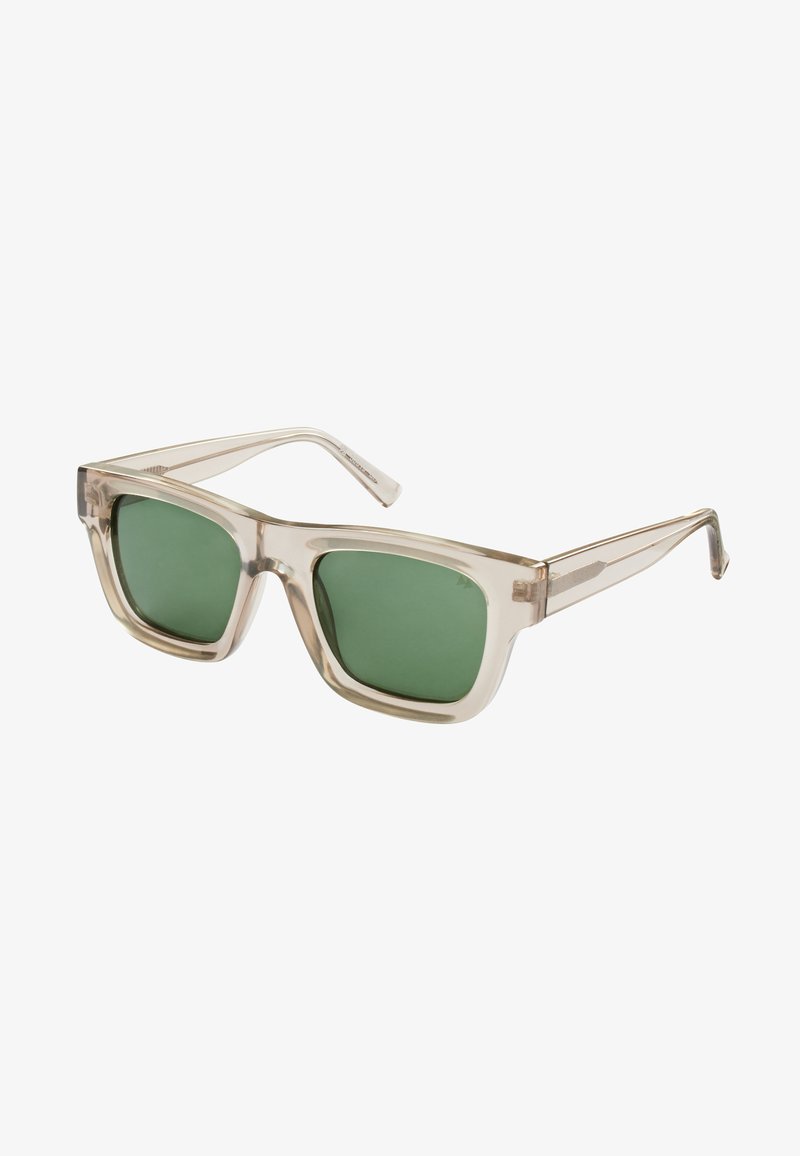 Gafas de sol con marco transparente y lentes verdes, de forma cuadrada y patillas elegantes. Destacan por su diseño minimalista y su color claro.