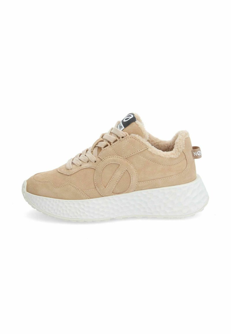 Beige suede sneakers with a fluffy lining, white textured sole, and lace-up design. Features a large logo on the side and heel tab.