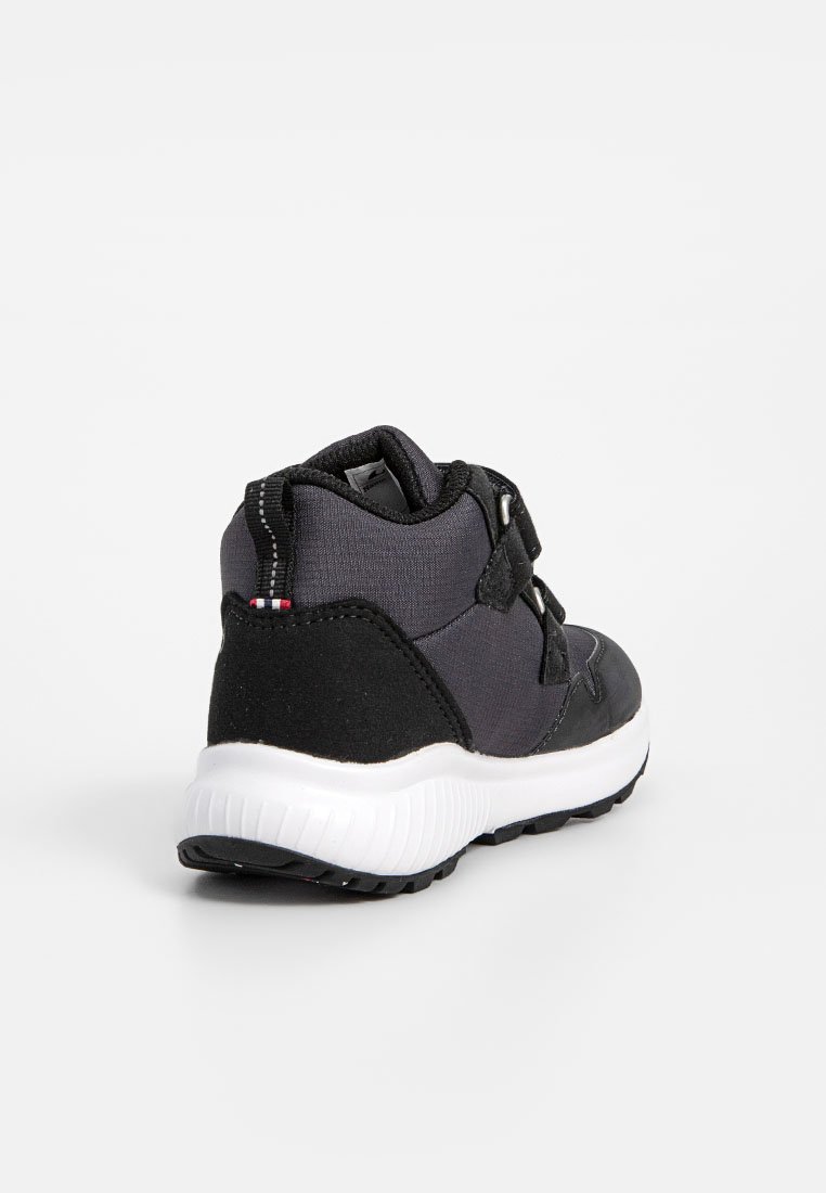 Schwarzer und grauer High-Top Sneaker mit weißer Sohle, Klettverschlussriemen und Zugschlaufe mit kleinem rot-weißen und blauen Streifen an der Ferse.