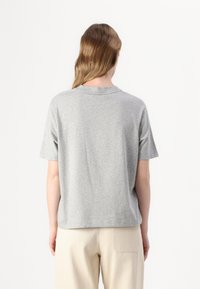 Gray cotton t-shirt with short sleeves, a crew neckline, and a relaxed fit, featuring a smooth texture and no visible patterns or accents.