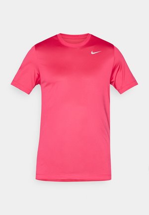 T-shirt rosa de mangas curtas feito de um tecido leve e suave. Apresenta um decote redondo e um pequeno logótipo da Nike em branco no peito.